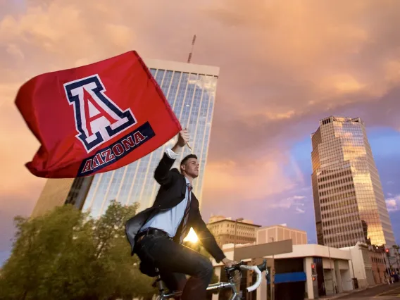 man on bicycle with flag