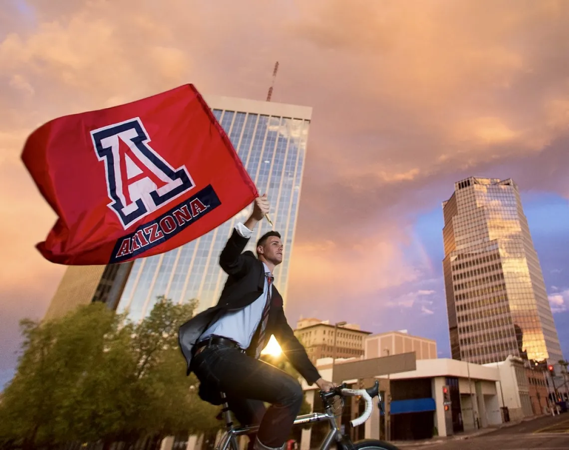 man on bicycle with flag