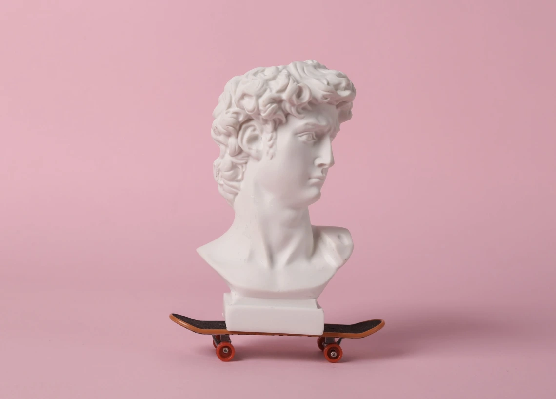 greek statue head on a toy skateboard