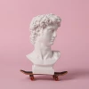 greek statue head on a toy skateboard