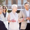 Pat Gerleman standing and speaking next to Suresh Garimella.