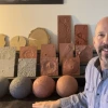 Steve Kortenkamp in front of a desk with lunar models of various colors